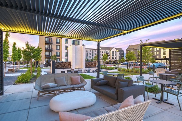 Courtyard oasis with modern seating and vibrant landscaping at Novel Daybreak Apartments