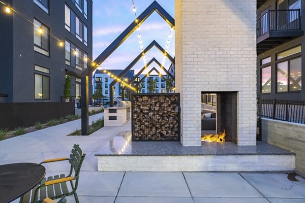 Cozy fire pit with seating area at Novel Daybreak Apartments, perfect for evening gatherings and relaxation
