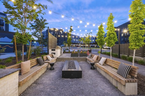 Outdoor fire pit area with cozy seating at Novel Daybreak Apartments