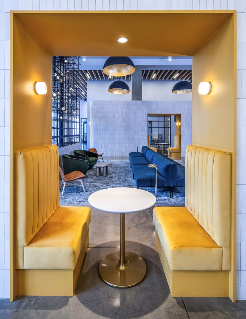Clubhouse at Otis Apartments featuring modern design and ample seating, setting for social gatherings in Greystar's luxury community