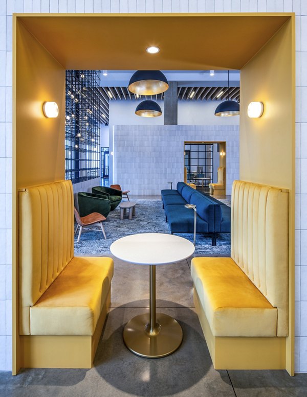 Clubhouse at Otis Apartments featuring modern design and ample seating, setting for social gatherings in Greystar's luxury community