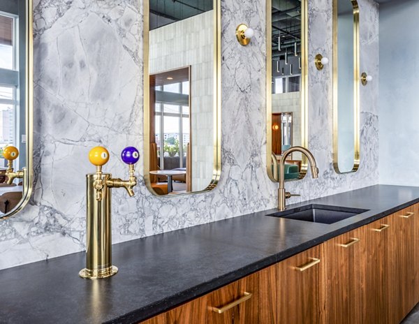 Clubhouse with cozy seating and billiards at Otis Apartments, a luxury community