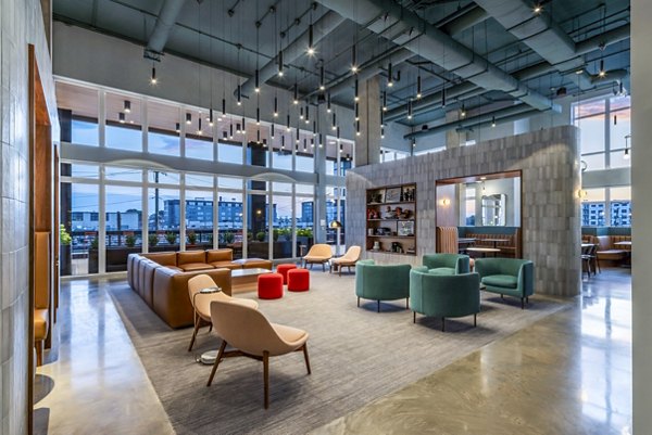Clubhouse at Otis Apartments: Modern social space with seating areas and entertainment options for residents to enjoy leisure activities