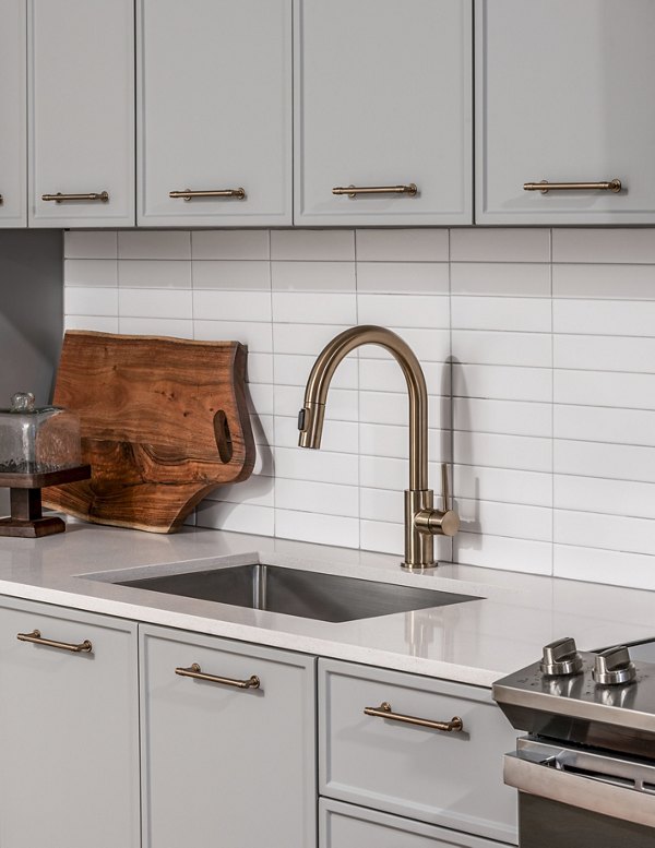 Modern kitchen featuring sleek countertops and stainless steel appliances at Otis Apartments