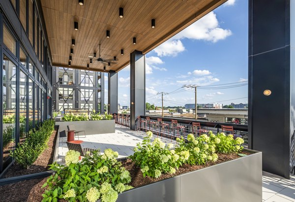 Spacious patio with modern seating at Otis Apartments, offering tranquil outdoor living