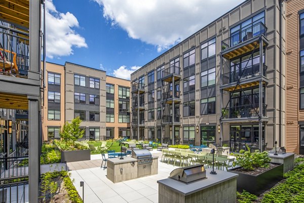 Cozy grill area on a stylish patio at Otis Apartments, perfect for outdoor gatherings
