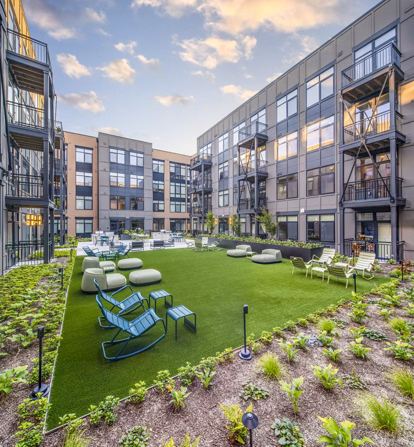 Chic patio courtyard with modern furniture at Otis Apartments, perfect for relaxation and social gatherings