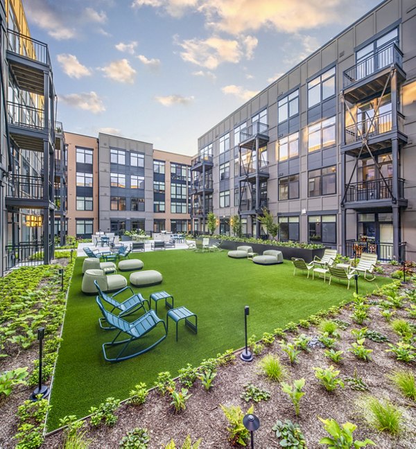 Chic patio courtyard with modern furniture at Otis Apartments, perfect for relaxation and social gatherings
