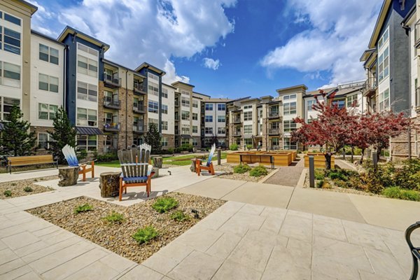 Spacious courtyard patio at Heights at Interlocken Apartments with lush landscaping and outdoor seating areas