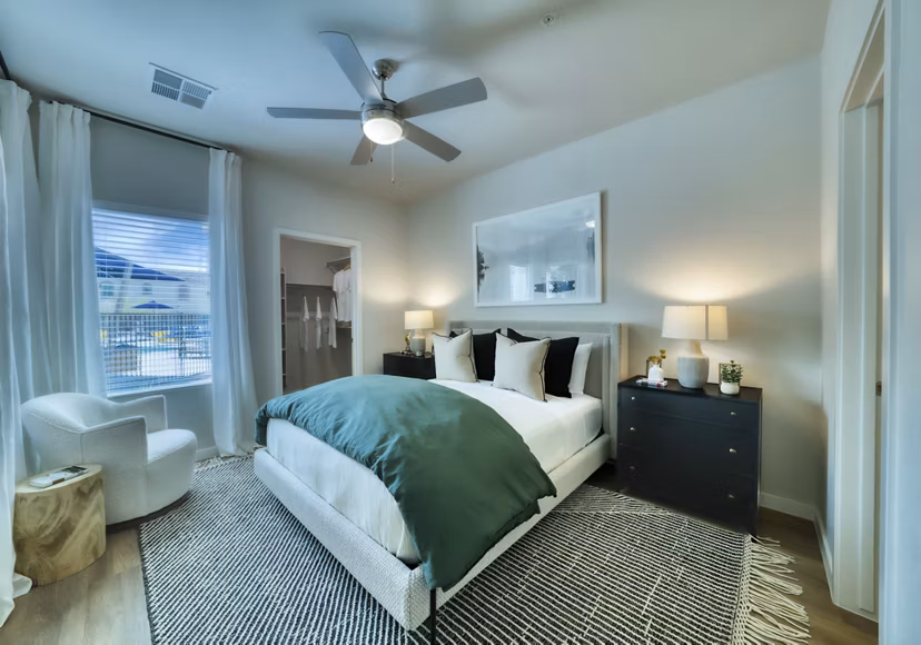 Modern bedroom with sleek decor at The Riley Apartments