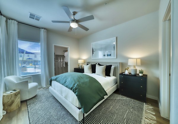 Modern bedroom with sleek decor at The Riley Apartments