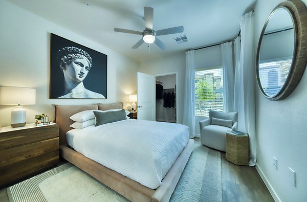Elegant bedroom with modern furniture and ambient lighting at The Riley Apartments, luxury living by Greystar