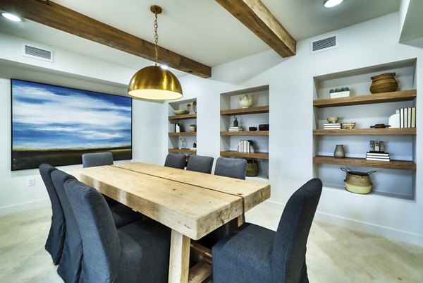 Meeting room equipped with modern conference tables and AV system at The Riley Apartments, ideal for business gatherings and events