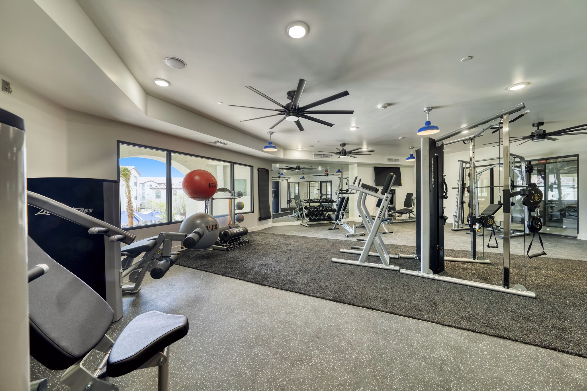 Modern fitness center with state-of-the-art equipment at The Riley Apartments