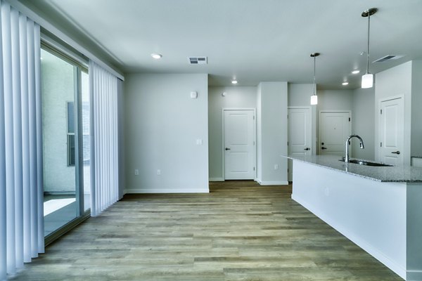 Modern kitchen with stainless steel appliances in The Riley Apartments
