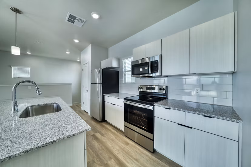 Stylish kitchen with modern appliances at The Riley Apartments, Greystar luxury property