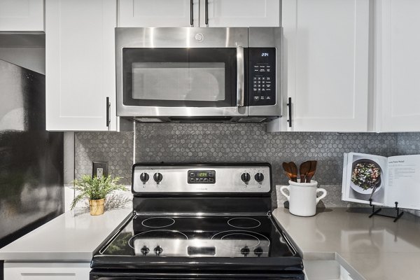 Modern kitchen with stainless steel appliances and granite countertops at Madera Ridge Apartments
