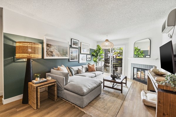 Spacious living room with modern decor in Madera Ridge Apartments featuring a cozy seating area and large windows for natural light
