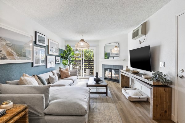 Spacious living room with modern decor and large windows in Madera Ridge Apartments