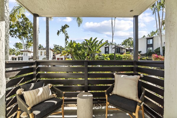 Spacious outdoor patio with seating and plants at Madera Ridge Apartments, offering relaxing views and luxury living amenities