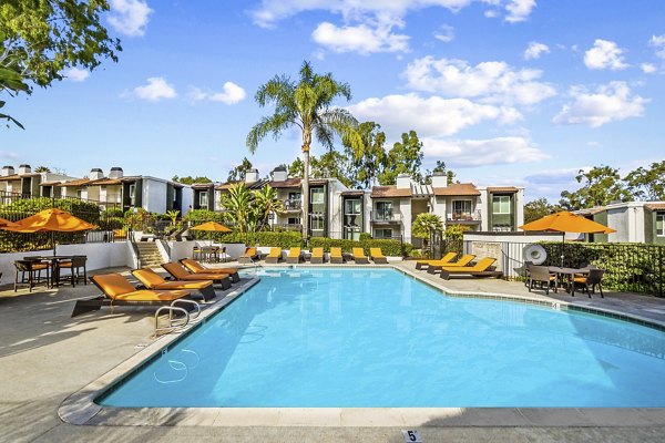 Resort-style pool with sun loungers at Madera Ridge Apartments offering luxury living in the heart of the city