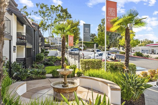 Courtyard with landscaped gardens at Madera Ridge Apartments, offering luxury living in a serene environment