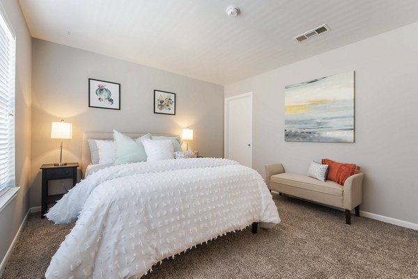 Cozy bedroom with modern decor in Parcside Townhomes Apartments