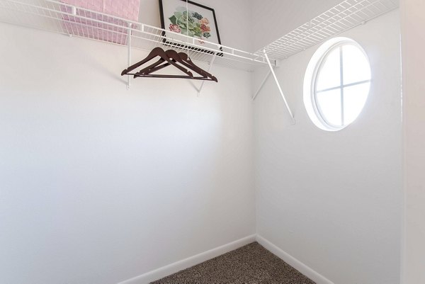 Spacious closet featuring built-in shelving in Parcside Townhomes Apartments