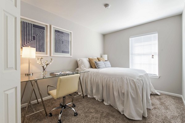 Cozy bedroom with neutral decor in Parcside Townhomes Apartments, offering comfort and style for modern living