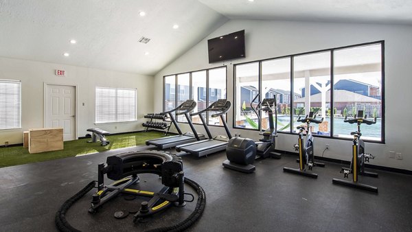 Fitness center in Parcside Townhomes Apartments featuring modern equipment and spacious workout areasâ€‹