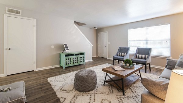 Cozy living room with modern decor and natural light at Parcside Townhomes Apartments