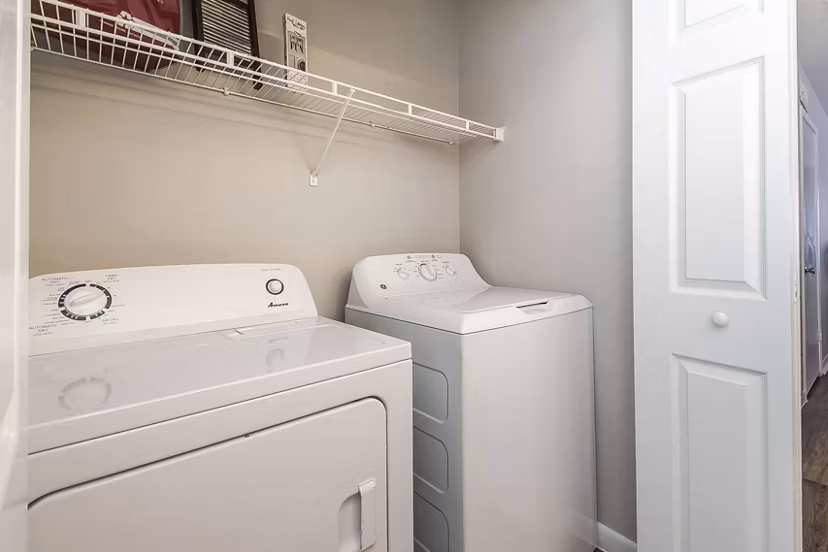 Laundry room with modern appliances in Parcside Townhomes Apartments, offering convenient in-unit laundry facilities