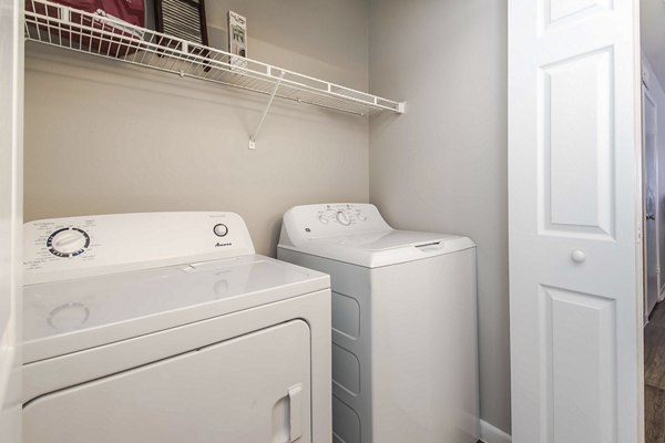 Laundry room with modern appliances in Parcside Townhomes Apartments, offering convenient in-unit laundry facilities