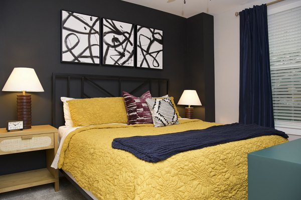 King-sized bed with modern linens in a luxurious bedroom at Broadstone Centennial Apartments
