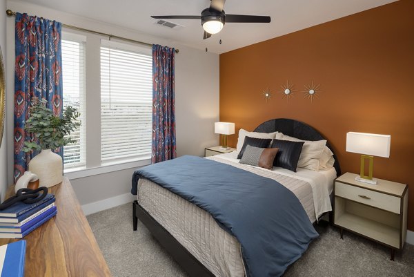 Spacious bedroom with large windows at Broadstone Centennial Apartments
