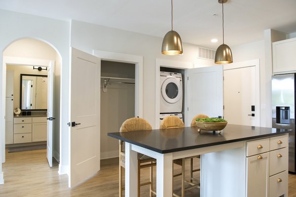 Modern kitchen with stainless steel appliances in Novel University Place Apartments
