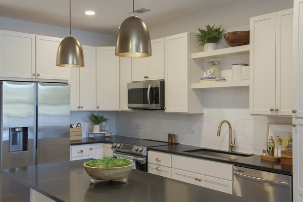 Modern kitchen with sleek countertops and stainless steel appliances at Novel University Place Apartments