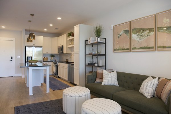 Spacious living room with modern decor in Novel University Place Apartments