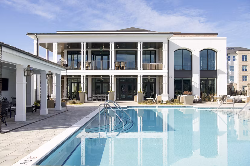 Luxurious pool with lounge seating at Novel University Place Apartments