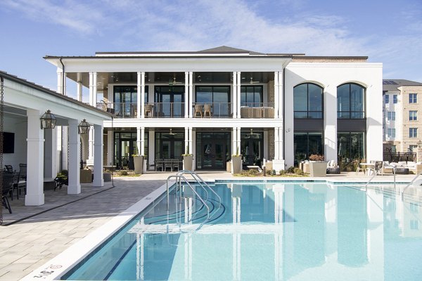 Luxurious pool with lounge seating at Novel University Place Apartments