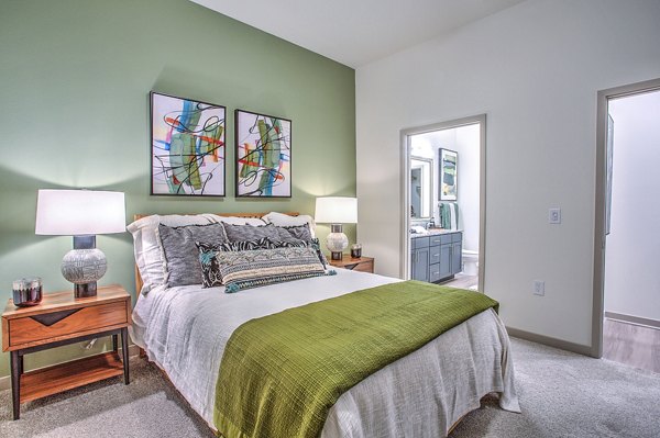 Cozy bedroom with modern furnishings and ample natural light at McKinney Terrace Apartments