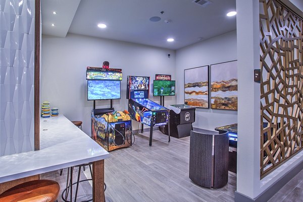 Clubhouse game room with pool tables and seating at McKinney Terrace Apartments, perfect for gatherings and entertainment