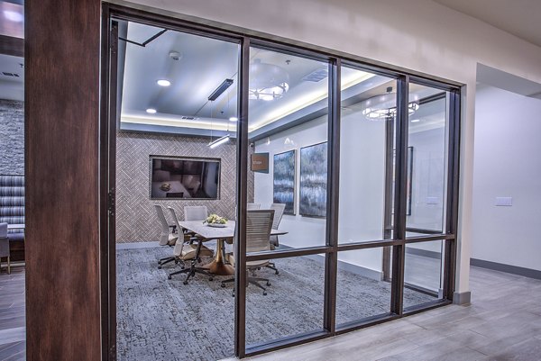 Clubhouse meeting room featuring modern decor and seating at McKinney Terrace Apartments