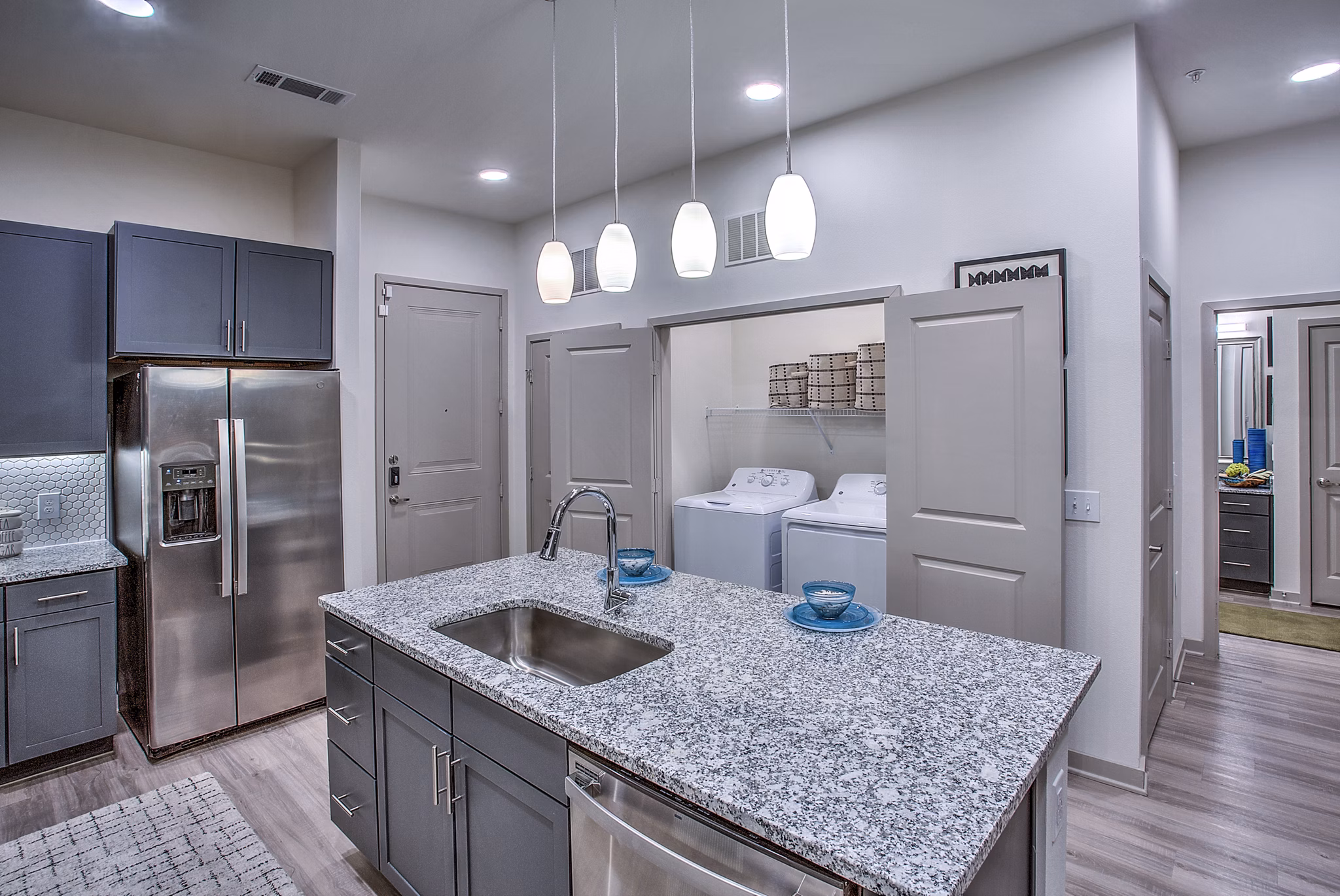 Spacious dining area with modern laundry room at McKinney Terrace Apartments, featuring contemporary design elements for luxury living