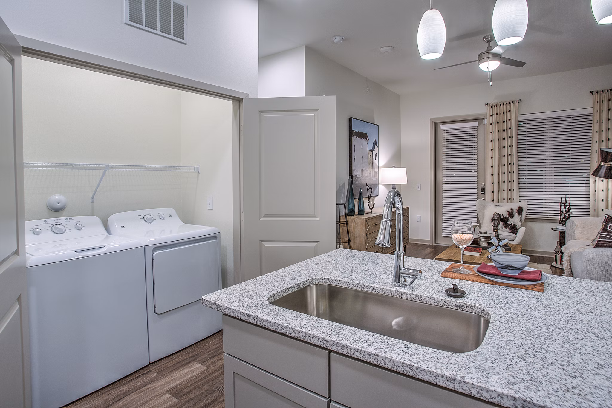 Modern laundry room with high-efficiency washers and dryers at McKinney Terrace Apartments, luxury living by Greystar