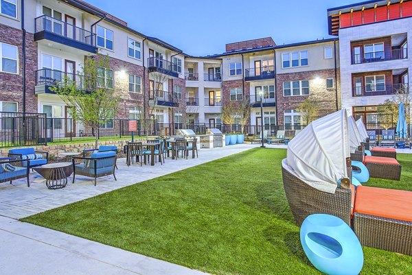 Outdoor grill area and patio at McKinney Terrace Apartments, ideal for community gatherings and relaxation