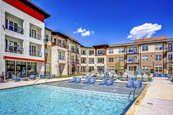 Resort-style sparkling pool at McKinney Terrace Apartments with luxurious lounging areas