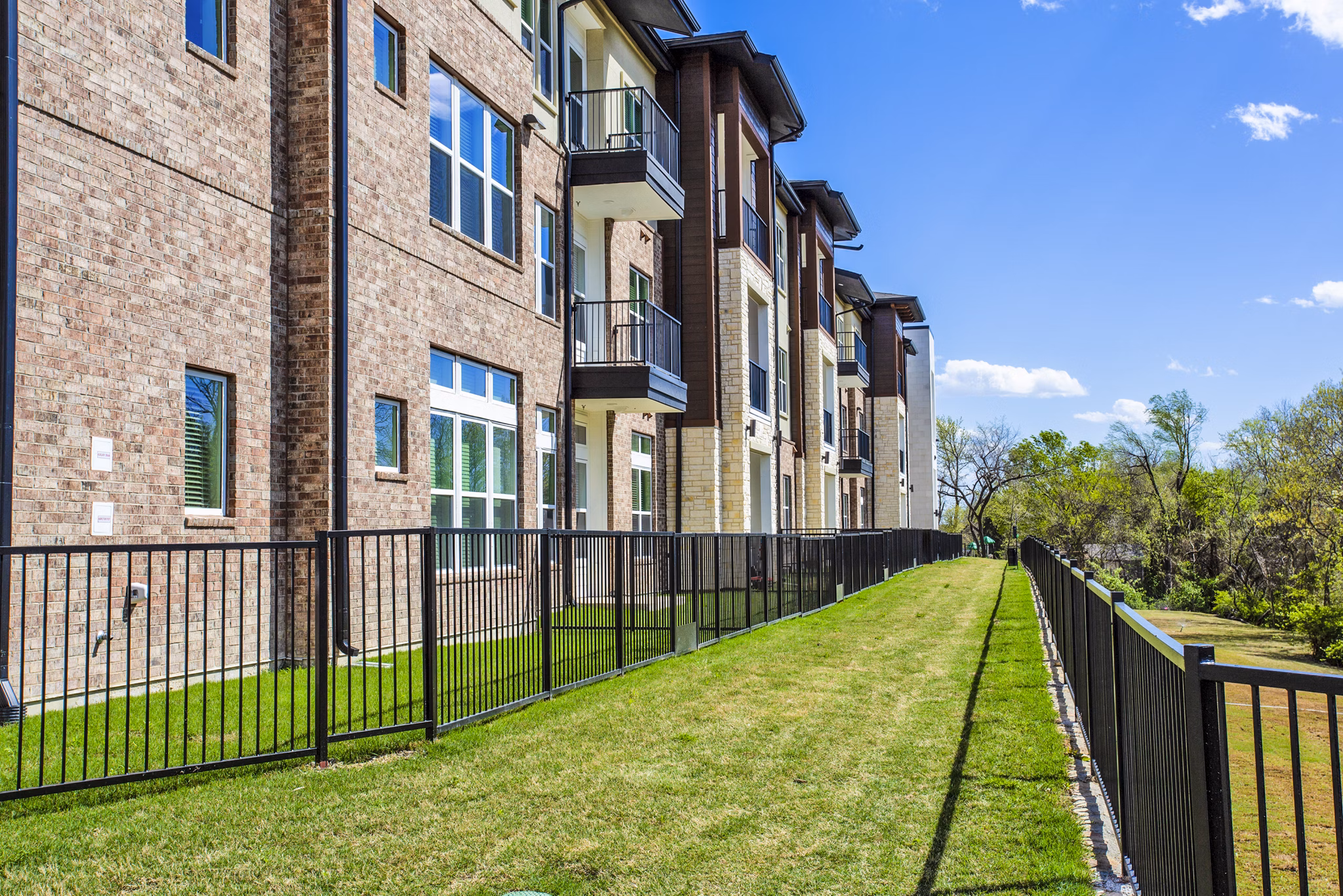 Dog park at McKinney Terrace Apartments with agility equipment and open green space for pet-friendly living