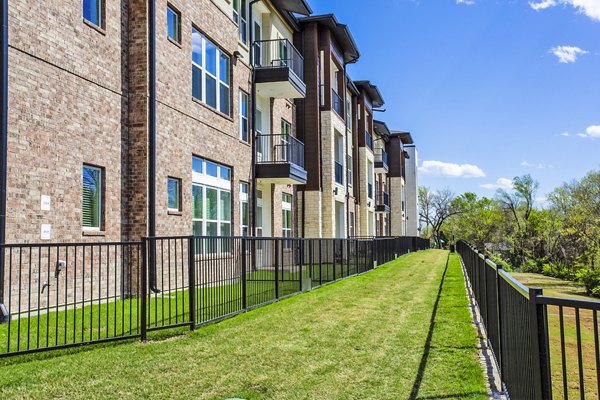 Dog park at McKinney Terrace Apartments with agility equipment and open green space for pet-friendly living