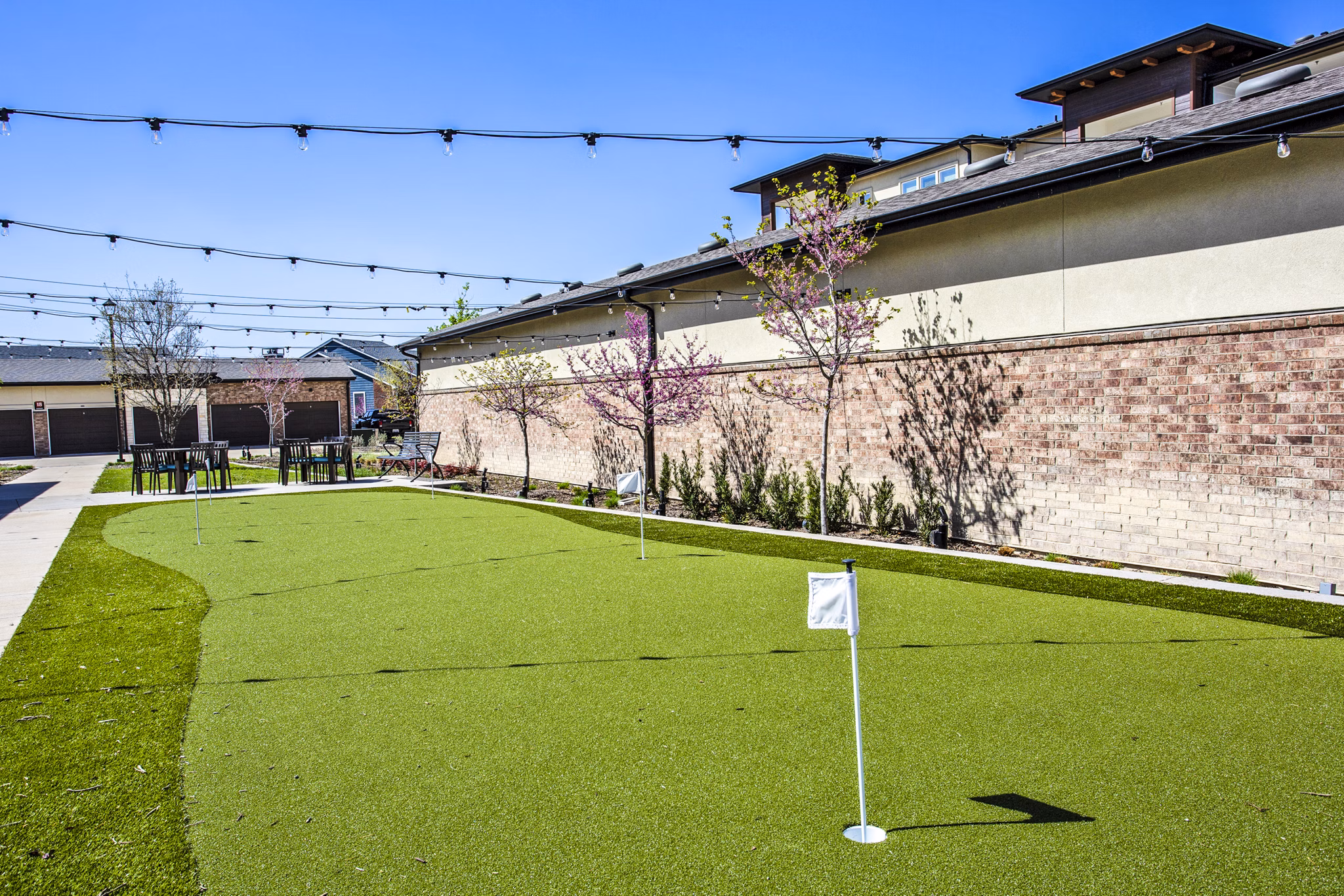 Golf putting practice area with lush greenery at McKinney Terrace Apartments Perfect for golf enthusiasts seeking leisure and recreation